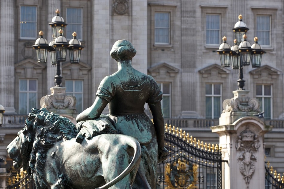 London: Skulptur Löwe mit Frau vor goldenem Zaun des Buckingham Palace London: Skulptur Löwe mit Frau vor goldenem Zaun des Buckingham Palace
